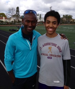 Lagat posing withi young St. Augustine Prep runner in San Diego