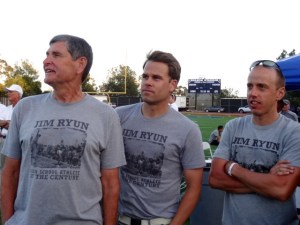 Jim Ryun in rapt attention with co-meet director Josh Cox, and American mile record holder Alan Webb