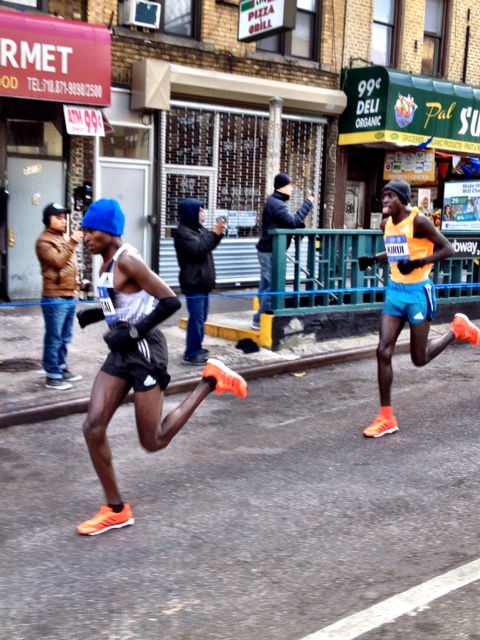 two-time defender Geoffrey Mutai up 4th Ave. in Brooklyn with Peter Kirui doing his Michael Jordan tongue wag in 2nd.