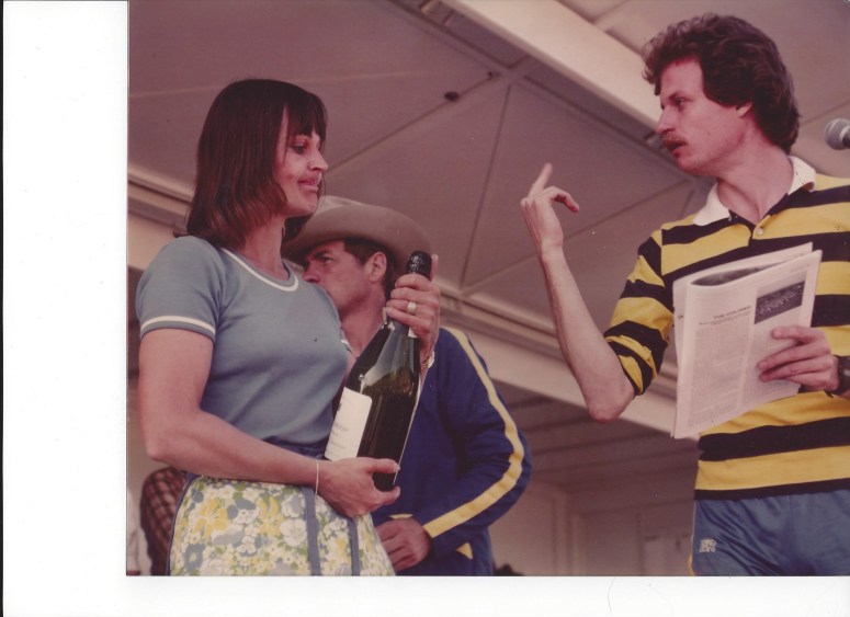 Me at the Midland Run 1980 award's ceremony upsetting once of the age-group winners. Race Director Bob Bright in cowboy hat behind.