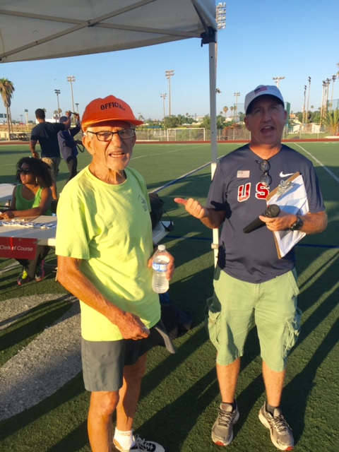 Paul Greer welcomes 84 year-pld Charles Kachadoorian, retired Air Force Master Sargeant as the men's mile is called.